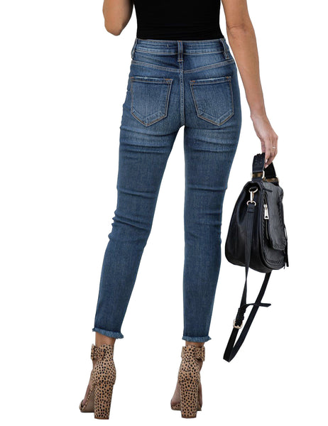 Back view of model wearing blue high-waist button-up frayed raw hem ripped cropped jeans