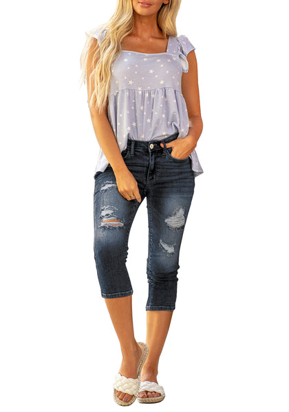 Full front view of model wearing dark blue below knee cropped skinny denim jeans