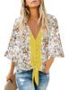 Front view of model wearing yellow color block floral V-neckline button-up tie-front top