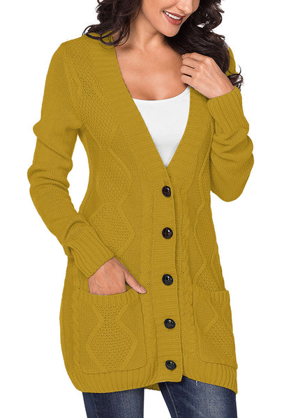 Model poses wearing mustard front pockets button-up cable knit cardigan