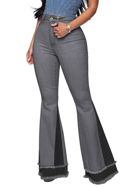 Front view of model wearing grey stretchy frayed hem flared denim jeans