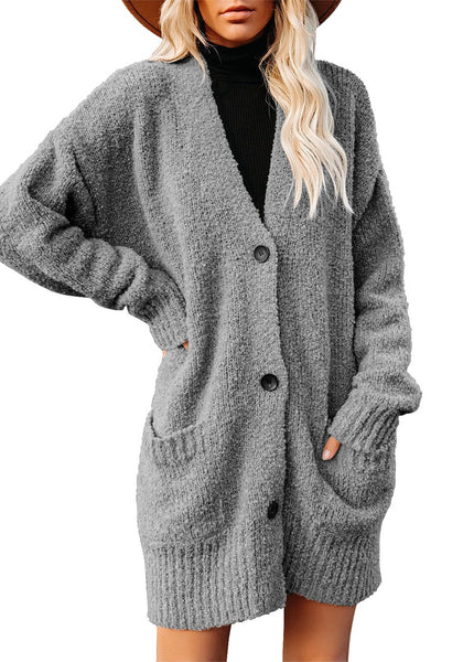 Front view of model wearing grey button down drop shoulders oversized knit cardigan
