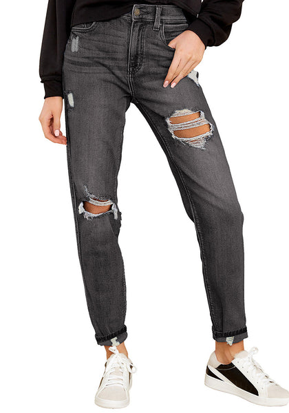 Model poses wearing dark grey cuffed ripped denim boyfriend jeans