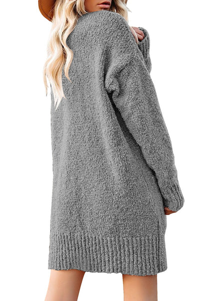 Back view of model wearing grey button down drop shoulders oversized knit cardigan
