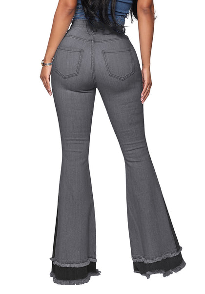 Back view of model wearing grey stretchy frayed hem flared denim jeans