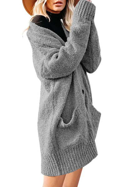 Side view of model wearing grey button down drop shoulders oversized knit cardigan