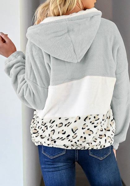 Back view of model wearing grey colorblock half-zip hooded fleece pullover