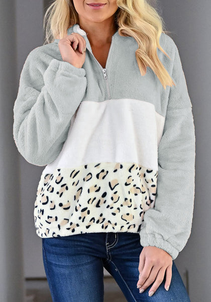 Model poses wearing grey colorblock half-zip hooded fleece pullover
