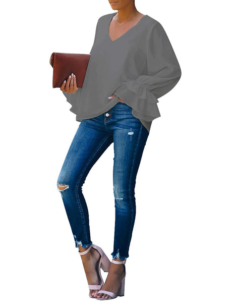 Full front view of model wearing grey ruffle cuff long sleeves V-neck blouse