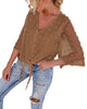 Angled view of model wearing coffee 3/4 sleeves pompom tie-front top