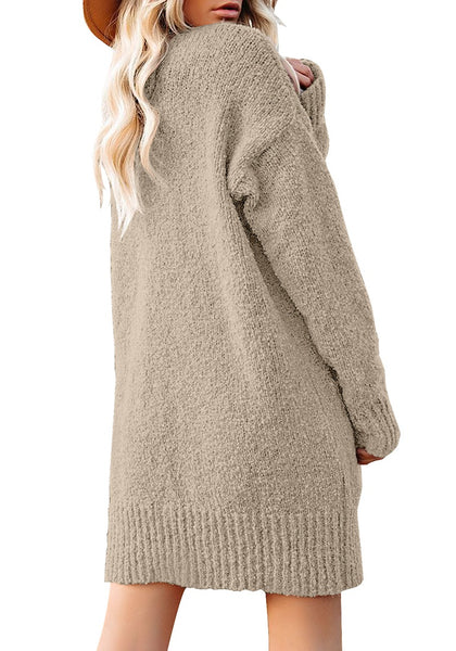 Back view of model wearing beige button down drop shoulders oversized knit cardigan