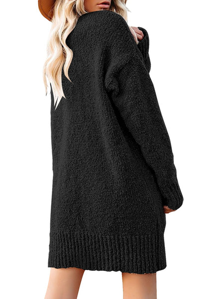 Back view of model wearing black button down drop shoulders oversized knit cardigan