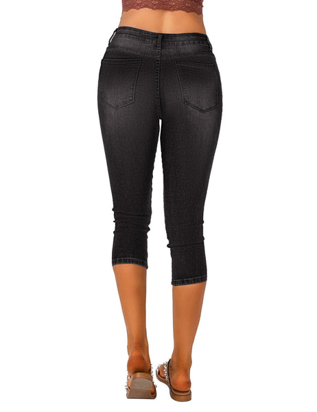 Back view of model wearing black below knee skinny fit jeans shorts