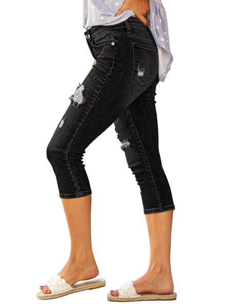 Side view of model wearing black below-knee cropped skinny denim jeans