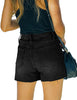 Back view of model wearing black raw hem mid-waist distressed denim shorts