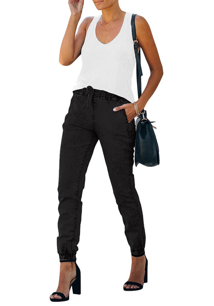 Angled shot of model wearing black elastic-waist welt pockets denim jogger pants
