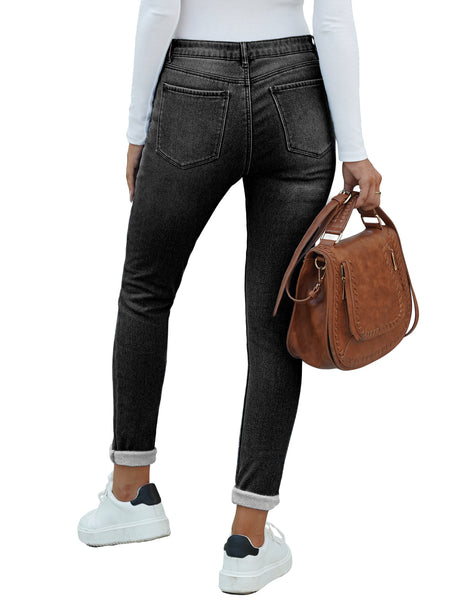 Back view of model wearing back fleece-lined button-down denim skinny jeans