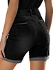 Back view of model wearing black rolled hem distressed biker shorts