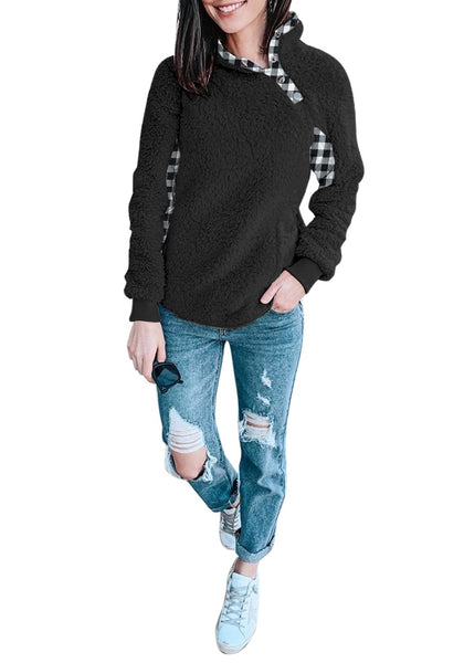 Full body shot of model wearing black split cowl neck plaid fleece sweater top