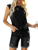 Front view of model wearing black rolled hem distressed biker shorts