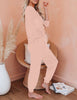 Side view of model wearing light pink solid color drawstring-waist jogger pajama set