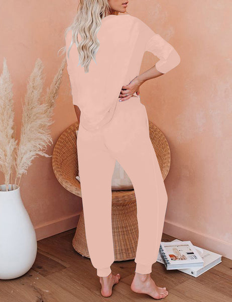 Back view of model wearing light pink solid color drawstring-waist jogger pajama set