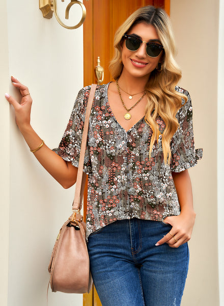 Front view of model wearing brown ruffle trim short sleeves floral V-neck button-down top