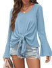 Front view of model wearing sky blue V-neckline trumpet sleeves tie-front blouse