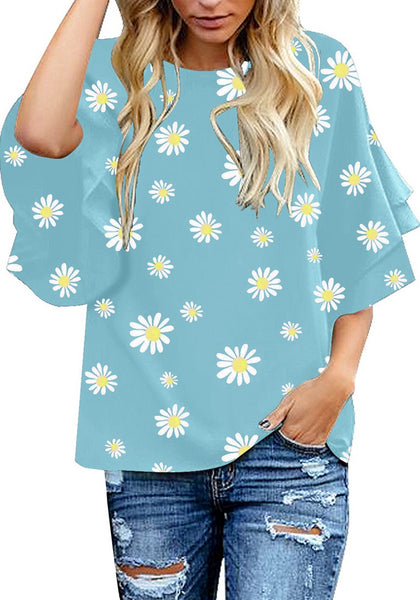 Front view of model wearing light blue trumpet sleeves keyhole-back daisy printed blouse