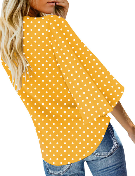 Back view of model wearing yellow polka dots V-neckline button-up tie-front top