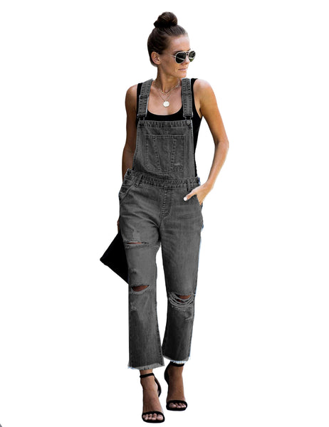 Front view of model wearing black cropped raw hem ripped denim bib overall
