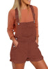 Front view of model wearing rust red rolled hem shorts denim bib overall