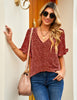 Front view of model wearing rust red ruffle trim short sleeves printed V-neck button-down top