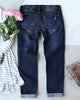 Back view of grey floral-print patch ripped rolled hem denim boyfriend jeans