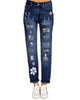 Front view of model wearing grey floral-print patch ripped rolled hem denim boyfriend jeans