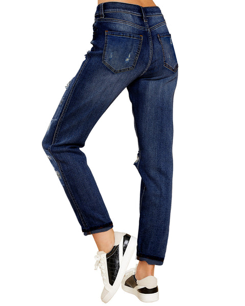 Back view of model wearing grey floral-print patch ripped rolled hem denim boyfriend jeans