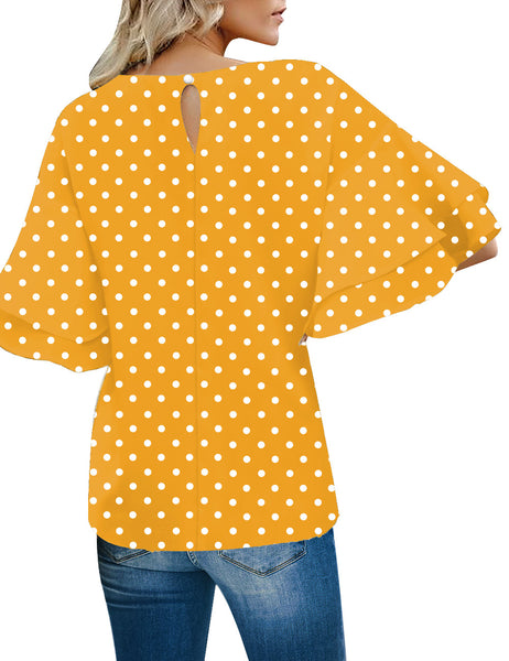 Back view of model wearing yellow polka dots trumpet sleeves keyhole-back blouse