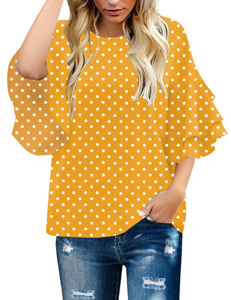 Front view of model wearing yellow polka dots trumpet sleeves keyhole-back blouse