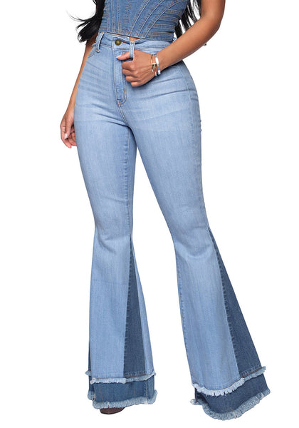 Front view of model wearing medium blue stretchy frayed hem flared denim jeans