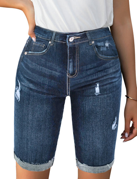 Front view of model wearing light blue mid-waist raw hem distressed denim bermuda shorts