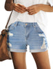 Model poses wearing light blue mid-waist rolled hem distressed denim shorts