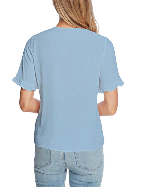 Back view of model wearing light blue ruffle trim short sleeves V-neck button-down top