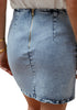 Back view of model wearing light blue acid wash tulip ruched denim mini skirt
