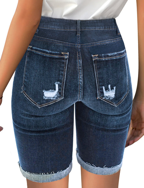 Back view of model wearing light blue mid-waist raw hem distressed denim bermuda shorts