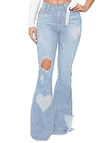 Model poses wearing light blue mid-waist ripped heart flared denim 