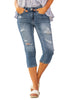 Model poses wearing light blue below knee cropped skinny denim jeans