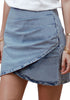Angled view of model wearing light blue acid wash tulip ruched denim mini skirt