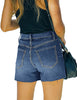 Back view of model wearing blue raw hem mid-waist distressed denim shorts