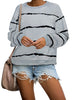 Posing model wearing grey striped drop shoulder pullover sweater