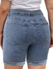 Back view of model wearing light blue high-waist cuffed hem distressed denim biker shorts